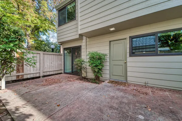 a backyard of house with trees and garage
