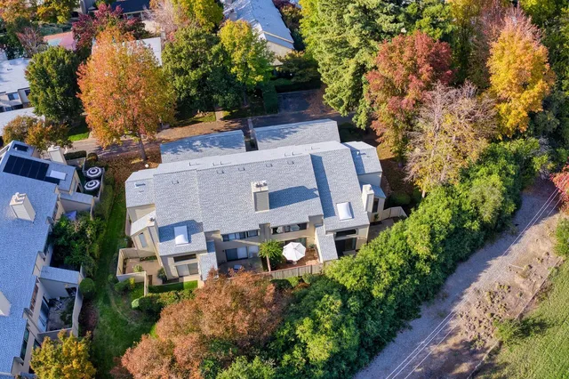 an aerial view of a house with garden space and street view