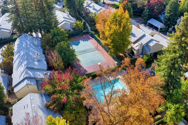 an aerial view of a house with a yard and garden