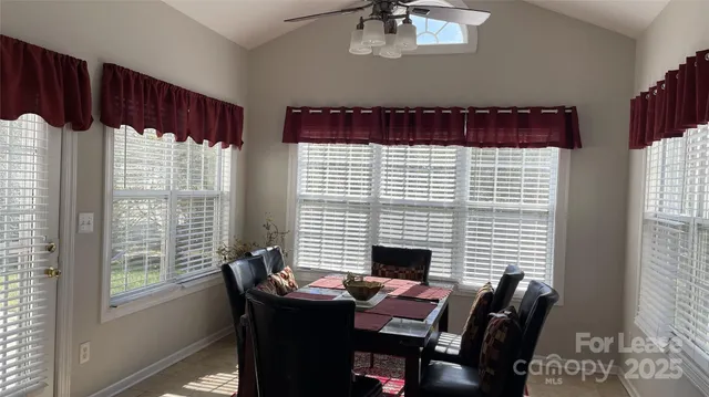 a view of a dining room with furniture and chandelier