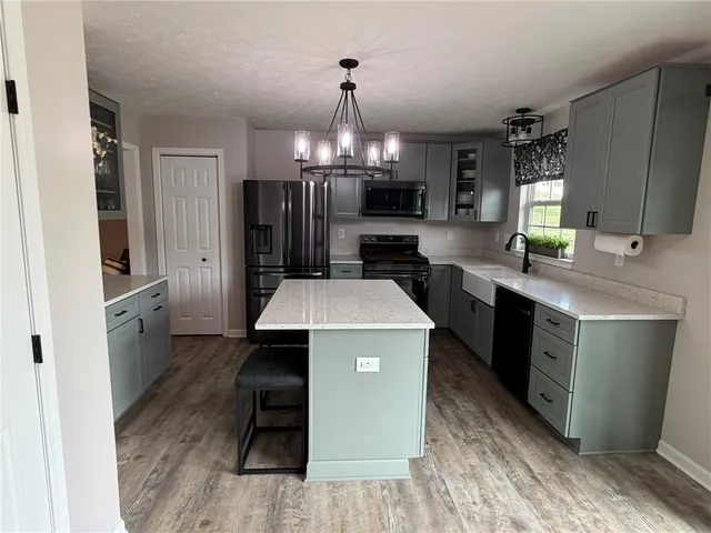 a kitchen with a sink stove and refrigerator