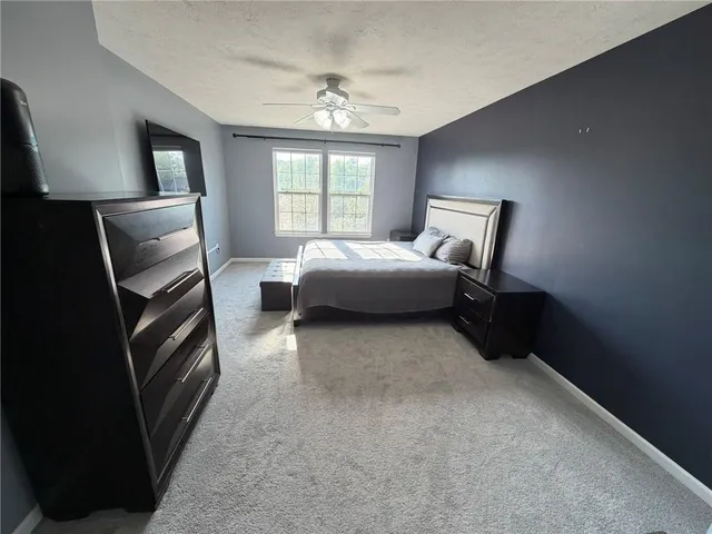 a bedroom with a bed and a tv