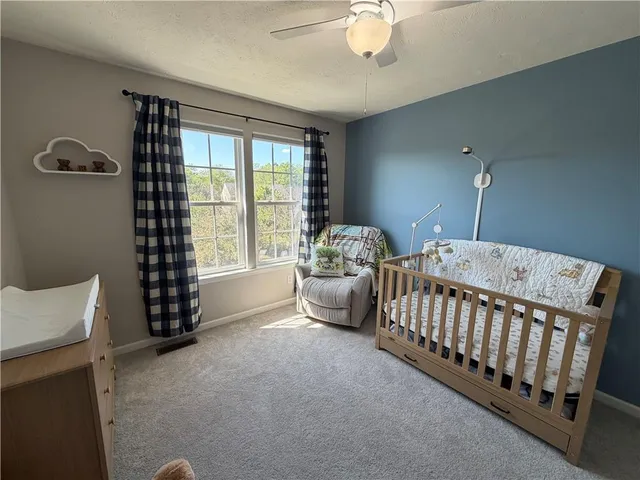 a bedroom with furniture and a large window