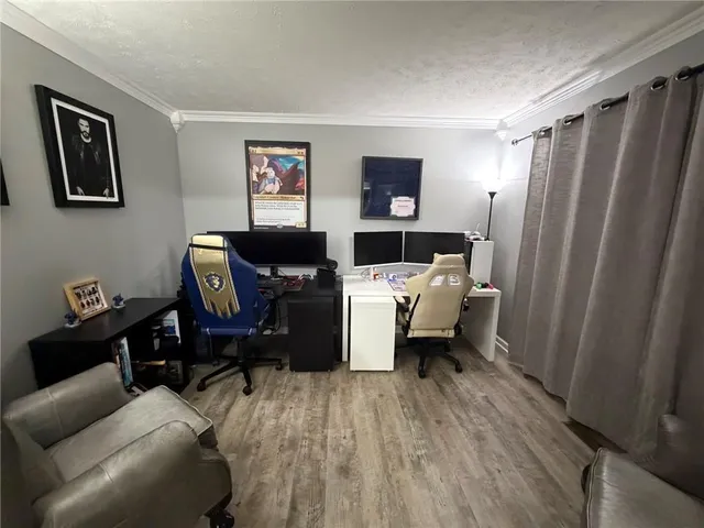 a living room with furniture a flat screen tv and a window