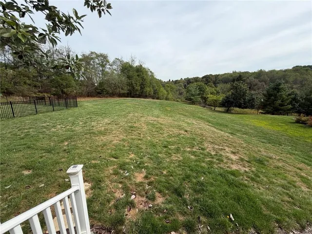 a view of a field with an trees in the background