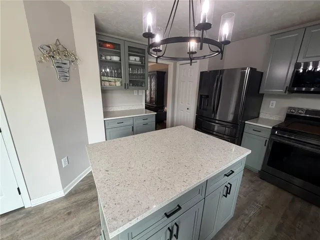 a kitchen with stainless steel appliances a refrigerator and a stove top oven