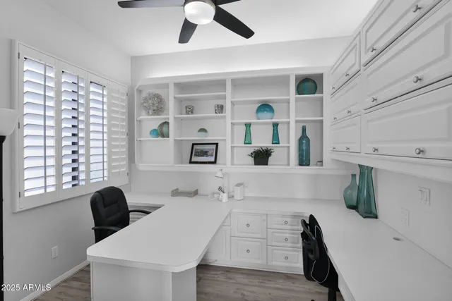 a view of a kitchen with granite countertop a stove a sink a dining table and chairs
