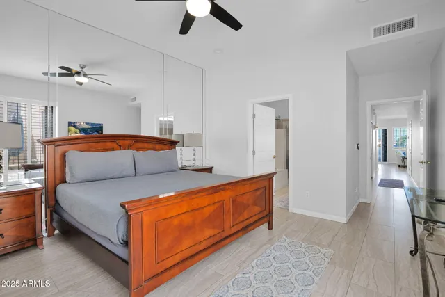 a living room with furniture and a ceiling fan