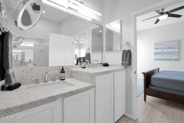 a bathroom with a double vanity sink and a mirror