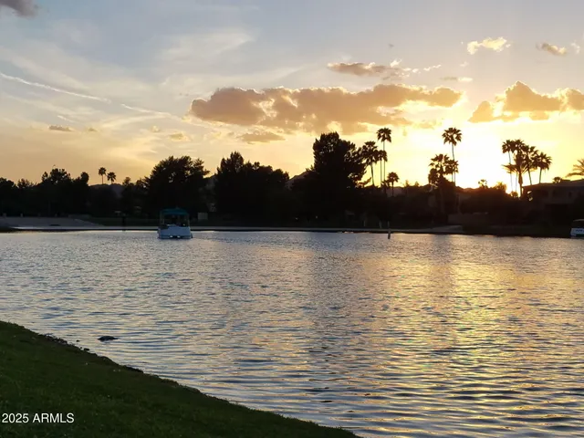 a view of a house with large windows and flower plants