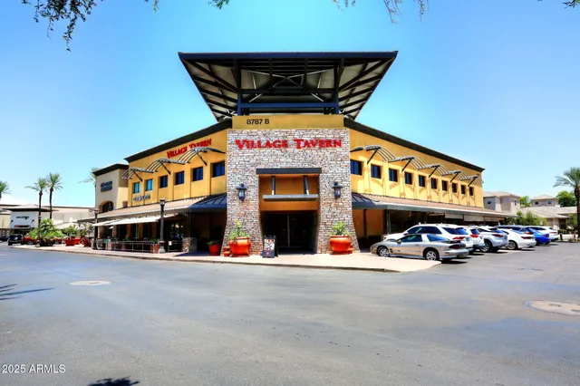 a balcony with furniture and a potted plant
