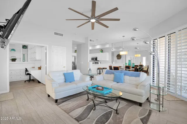 a living room with furniture and kitchen view