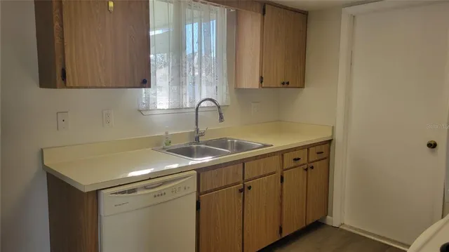 a kitchen with a sink and cabinets