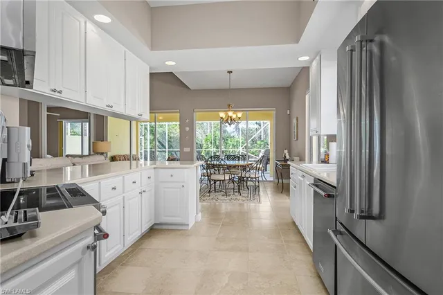a large white kitchen with lots of counter top space