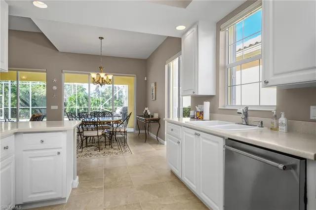 a kitchen with sink cabinets and dining table