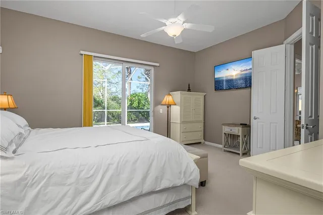 a bedroom with a large bed and a large window