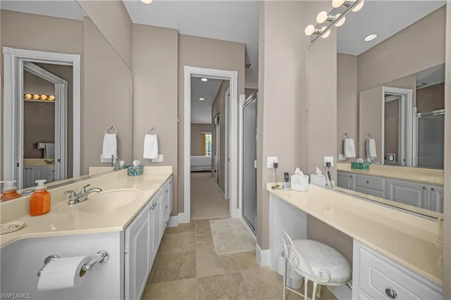 a large bathroom with a tub double sink and mirror