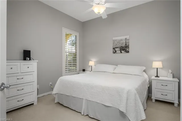 a bedroom with a bed and a night stand