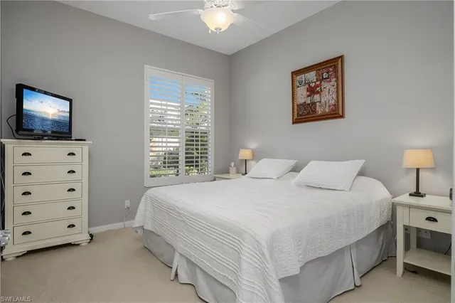 a bedroom with a bed and a tv on the dresser