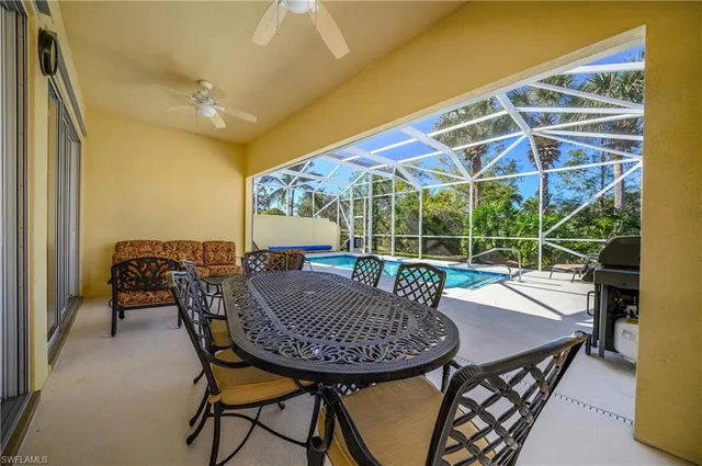 a view of a dining room with furniture and a floor to ceiling window