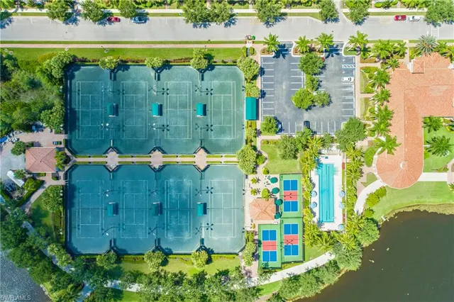 an aerial view of residential houses with outdoor space and street view
