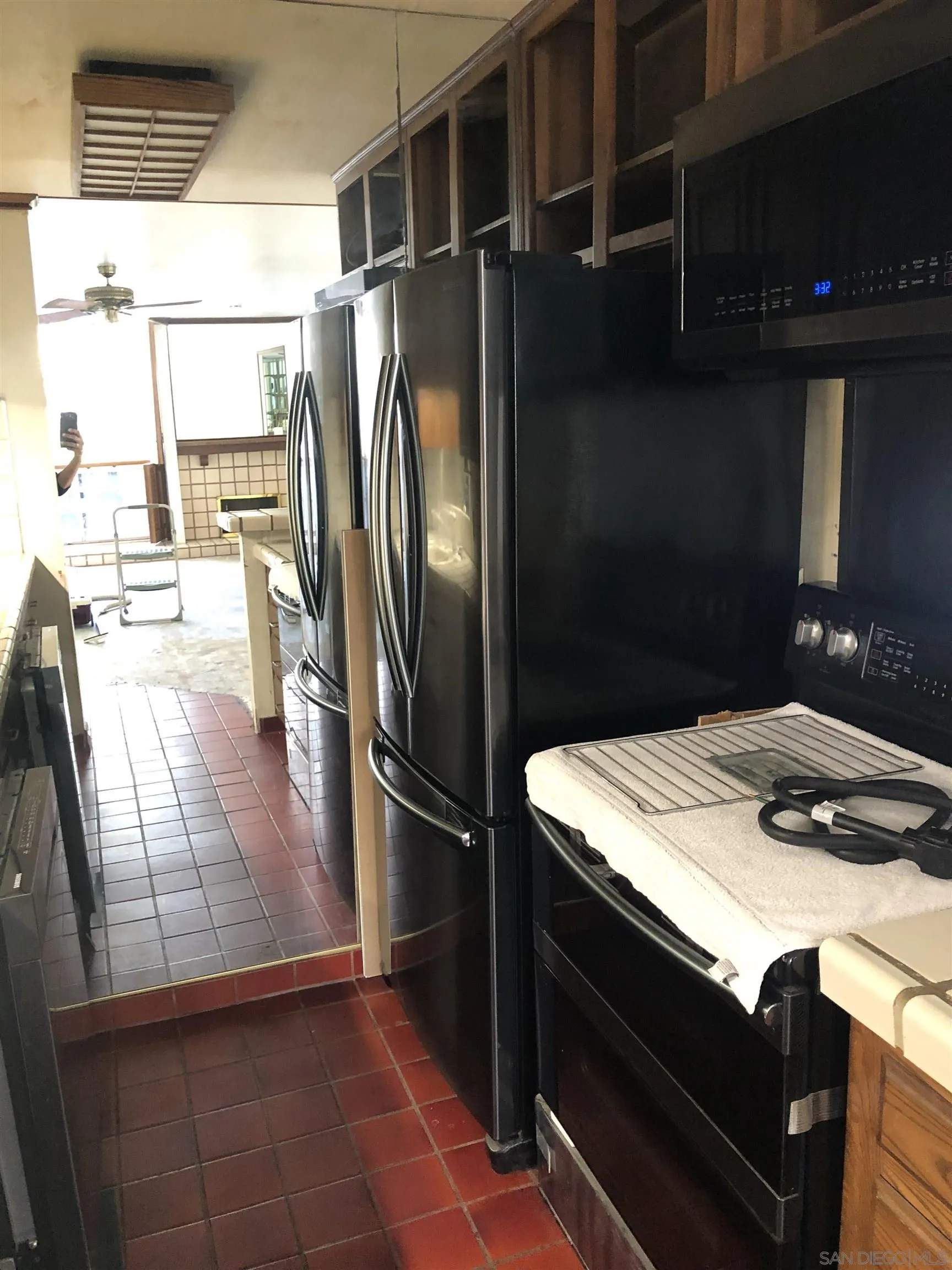 6202 Friars Road, Unit 224 San Diego, CA 92108 - Photo 7 of 13 a kitchen with kitchen island a counter appliances a sink and cabinets