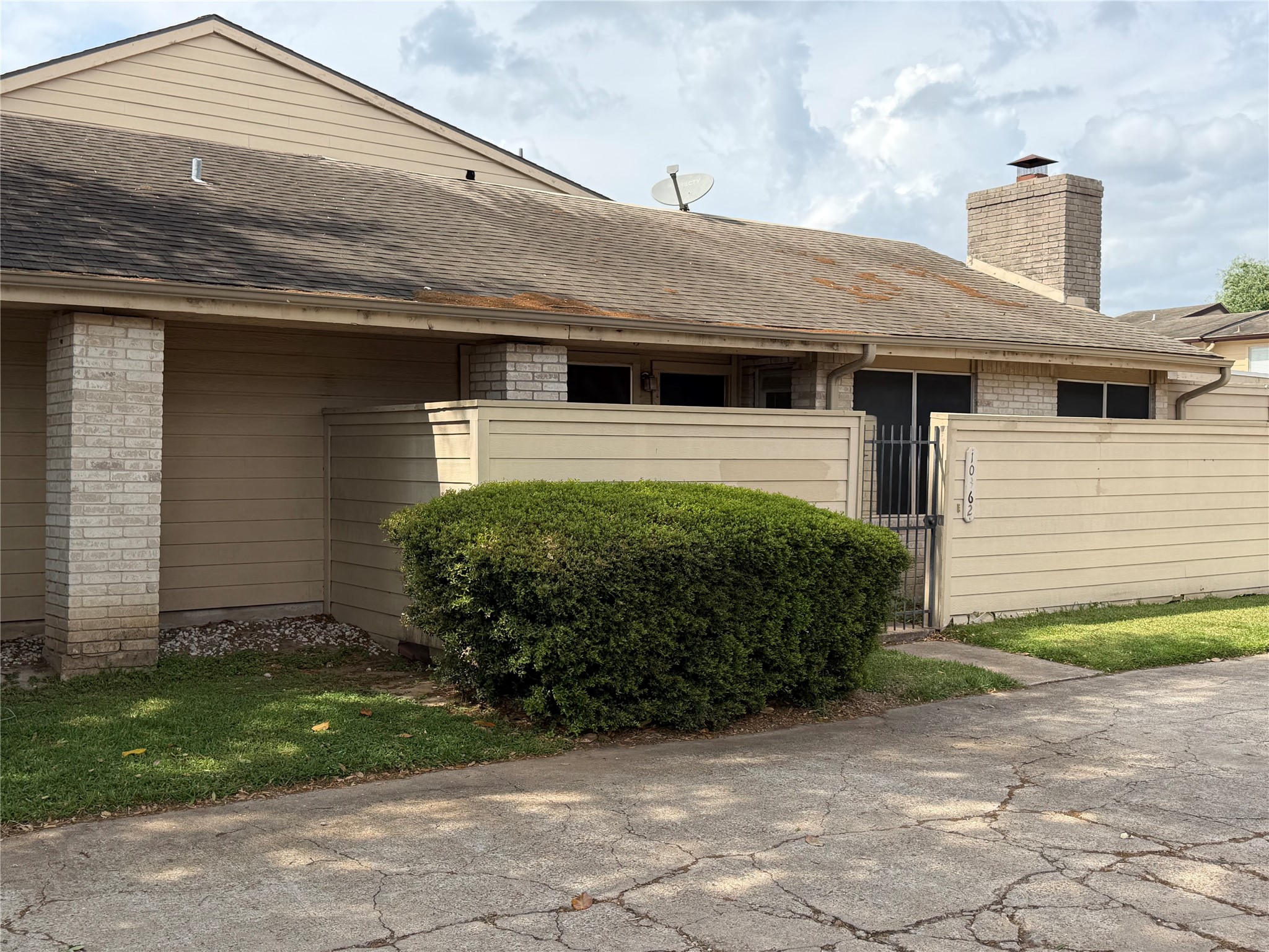 10362 Cook Road Houston, TX 77099 - Photo 1 of 16 a front view of a house with garden