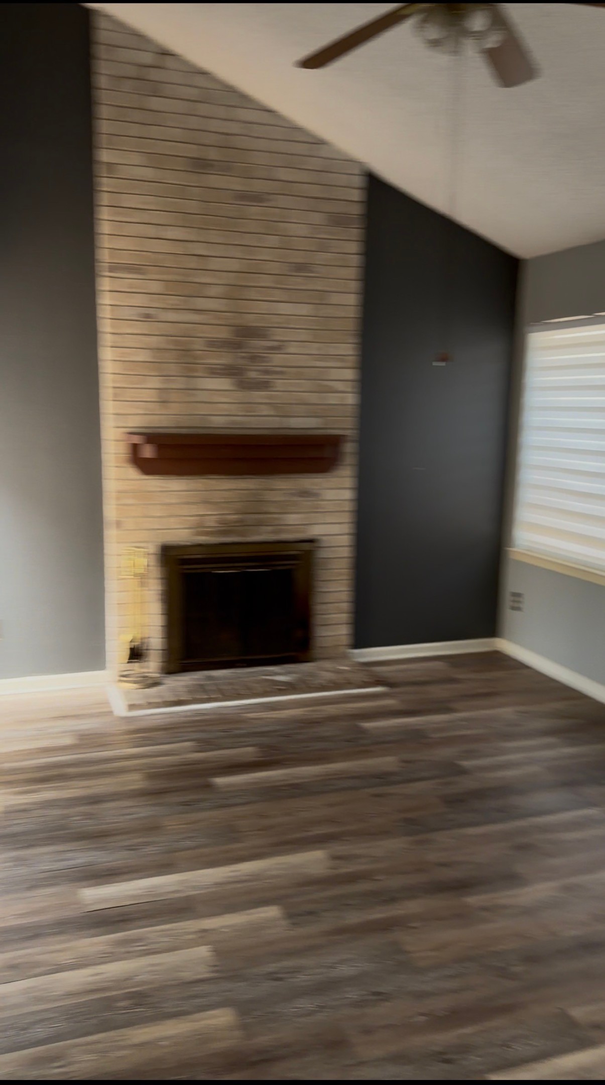 10362 Cook Road Houston, TX 77099 - Photo 8 of 16 a view of empty room with wooden floor and a fireplace