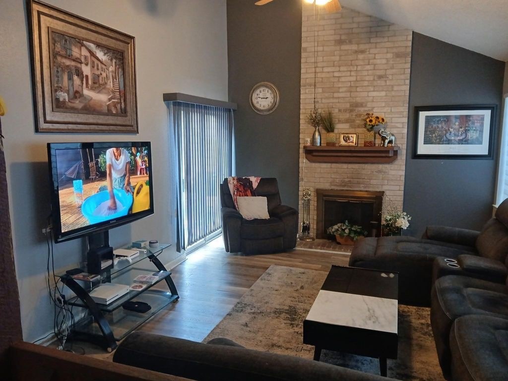 10362 Cook Road Houston, TX 77099 - Photo 9 of 16 a living room with furniture a rug and a fireplace