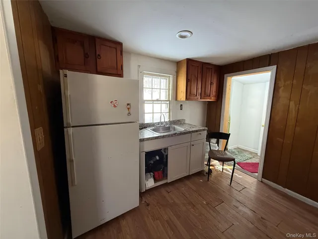 a kitchen with a refrigerator a sink and a window