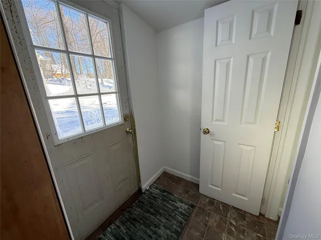 a view of an empty room and wooden floor