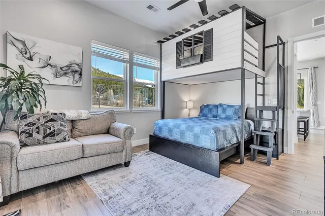 a bedroom with a large bed couch and a window