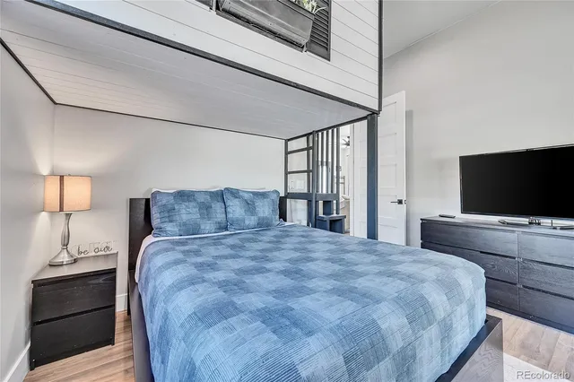 a bedroom with a bed and a flat screen tv