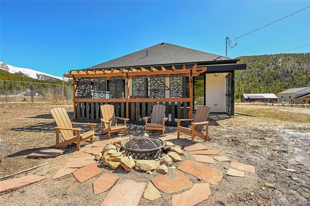 a view of a patio with a table and chairs under an umbrella