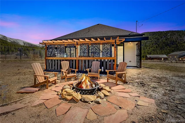 a view of a patio with table and chairs under an umbrella