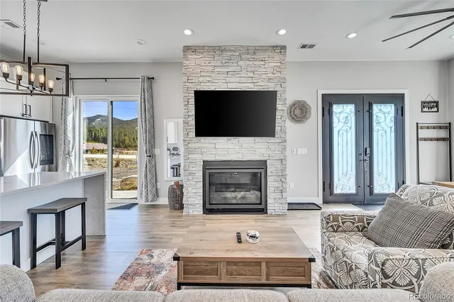 a living room with furniture a fireplace and a flat screen tv