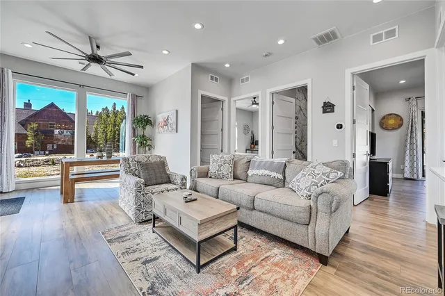 a living room with furniture and a large window