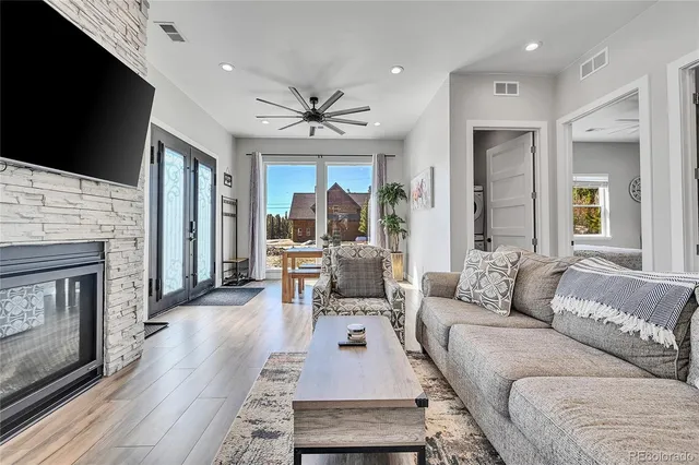 a living room with furniture a flat screen tv and a fireplace