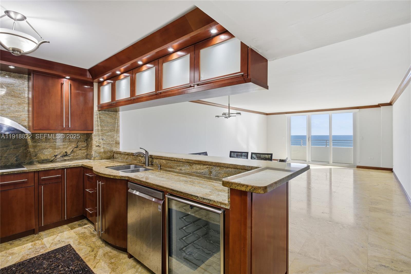 5555 Collins Avenue, Unit 12N Miami Beach, FL 33140 - Photo 16 of 49 a kitchen that has a sink and a stove in it
