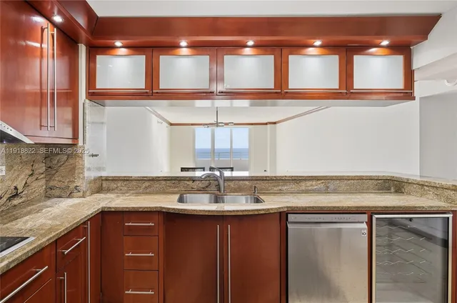 a kitchen with a sink a window and cabinets