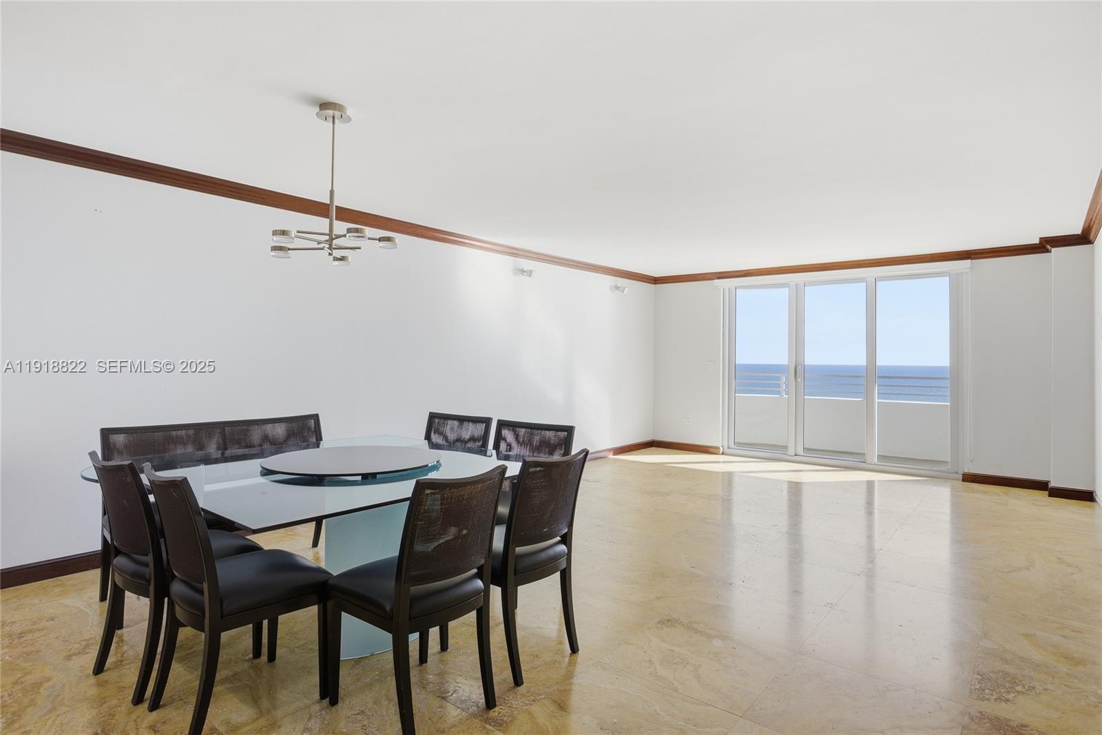 5555 Collins Avenue, Unit 12N Miami Beach, FL 33140 - Photo 20 of 49 a view of a dining room with furniture and wooden floor