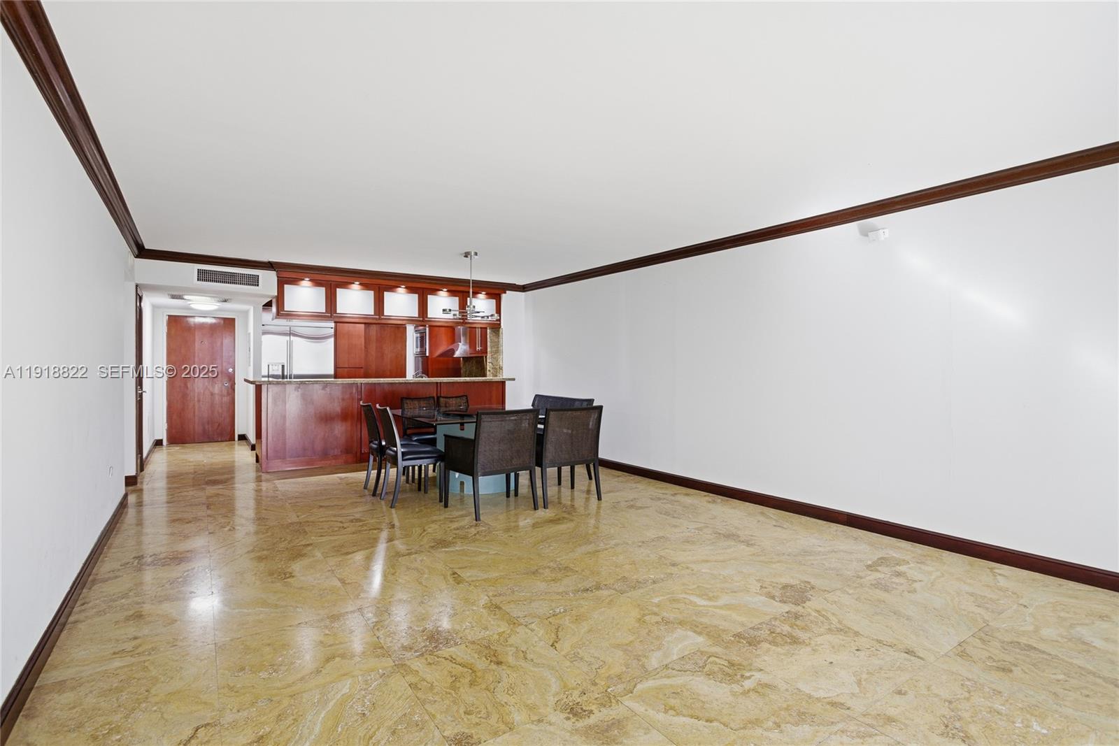 5555 Collins Avenue, Unit 12N Miami Beach, FL 33140 - Photo 21 of 49 a view of a dining room with furniture