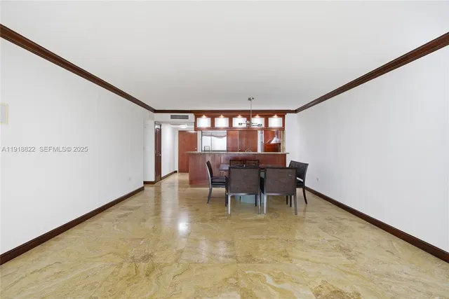 a dining room with furniture and a floor to ceiling window