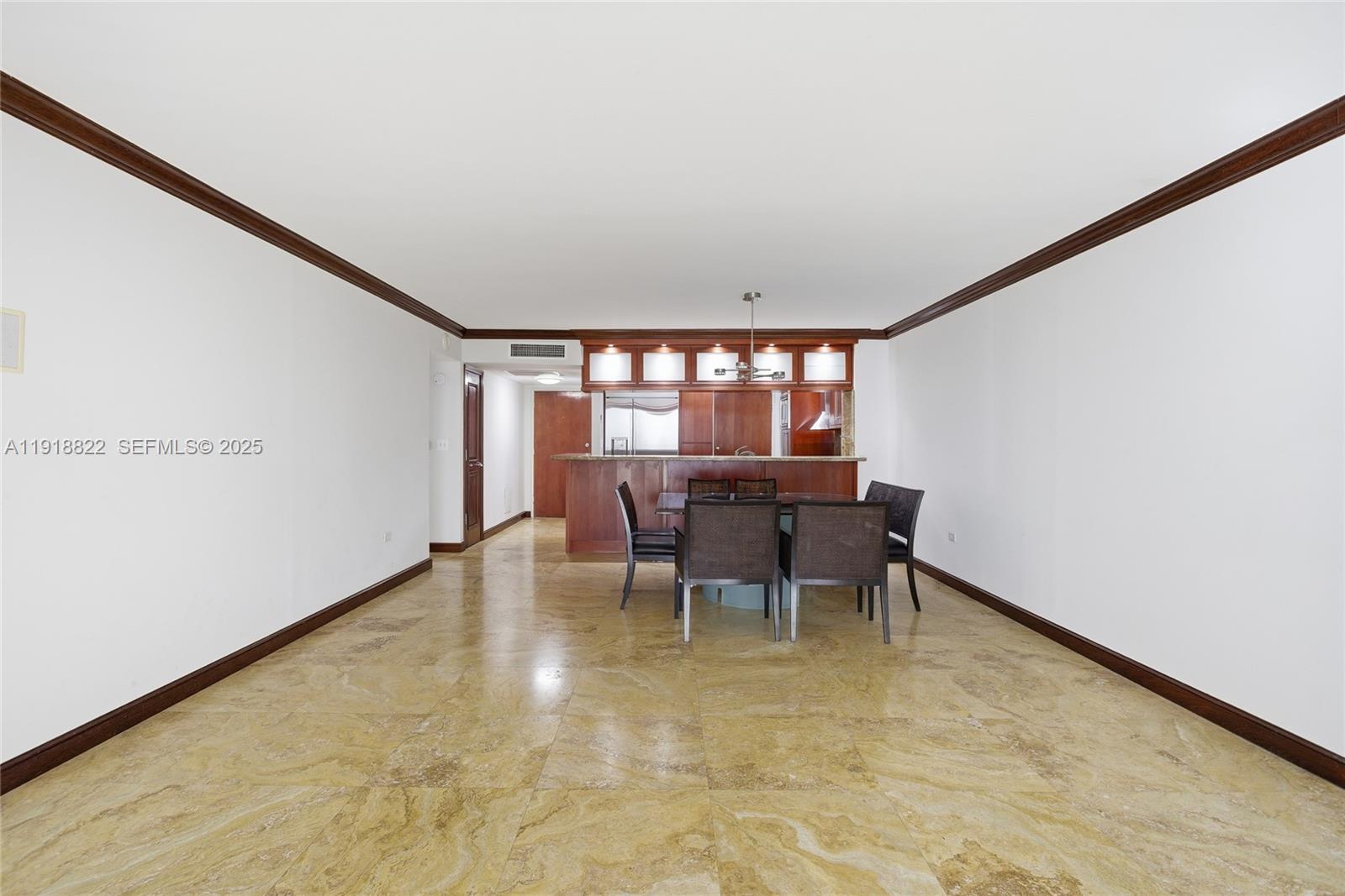 5555 Collins Avenue, Unit 12N Miami Beach, FL 33140 - Photo 22 of 49 a dining room with furniture and a floor to ceiling window