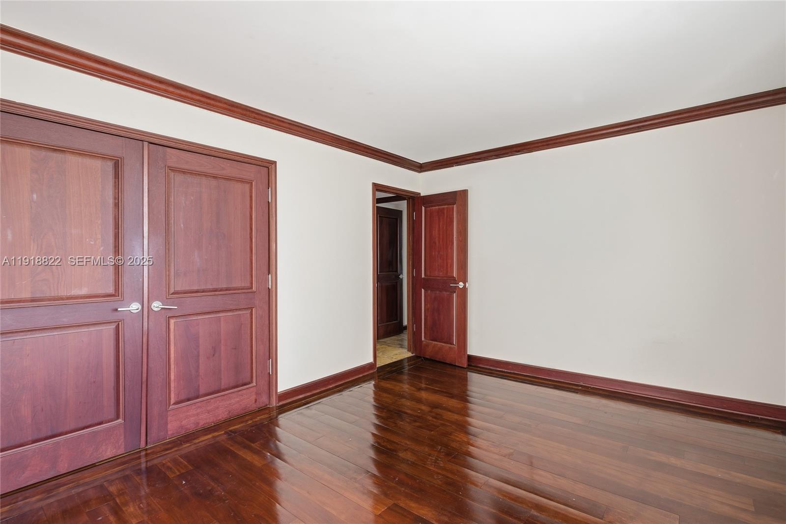 5555 Collins Avenue, Unit 12N Miami Beach, FL 33140 - Photo 25 of 49 a view of an empty room with wooden floor