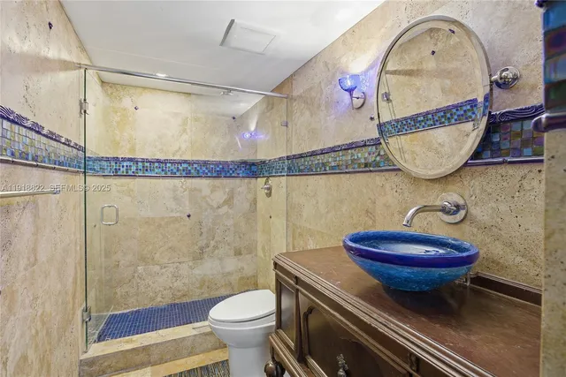 a bathroom with a sink a mirror and a toilet