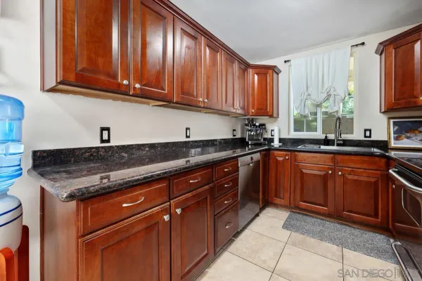 a kitchen with stainless steel appliances granite countertop a sink stove and cabinets