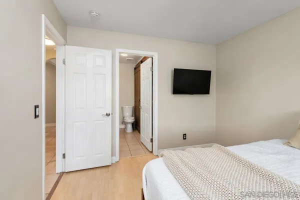 a bedroom with a bed and a flat screen tv