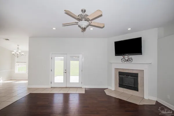 a view of livingroom with chandelier fan and window