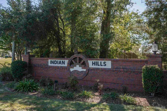 a sign that is sitting on a brick wall